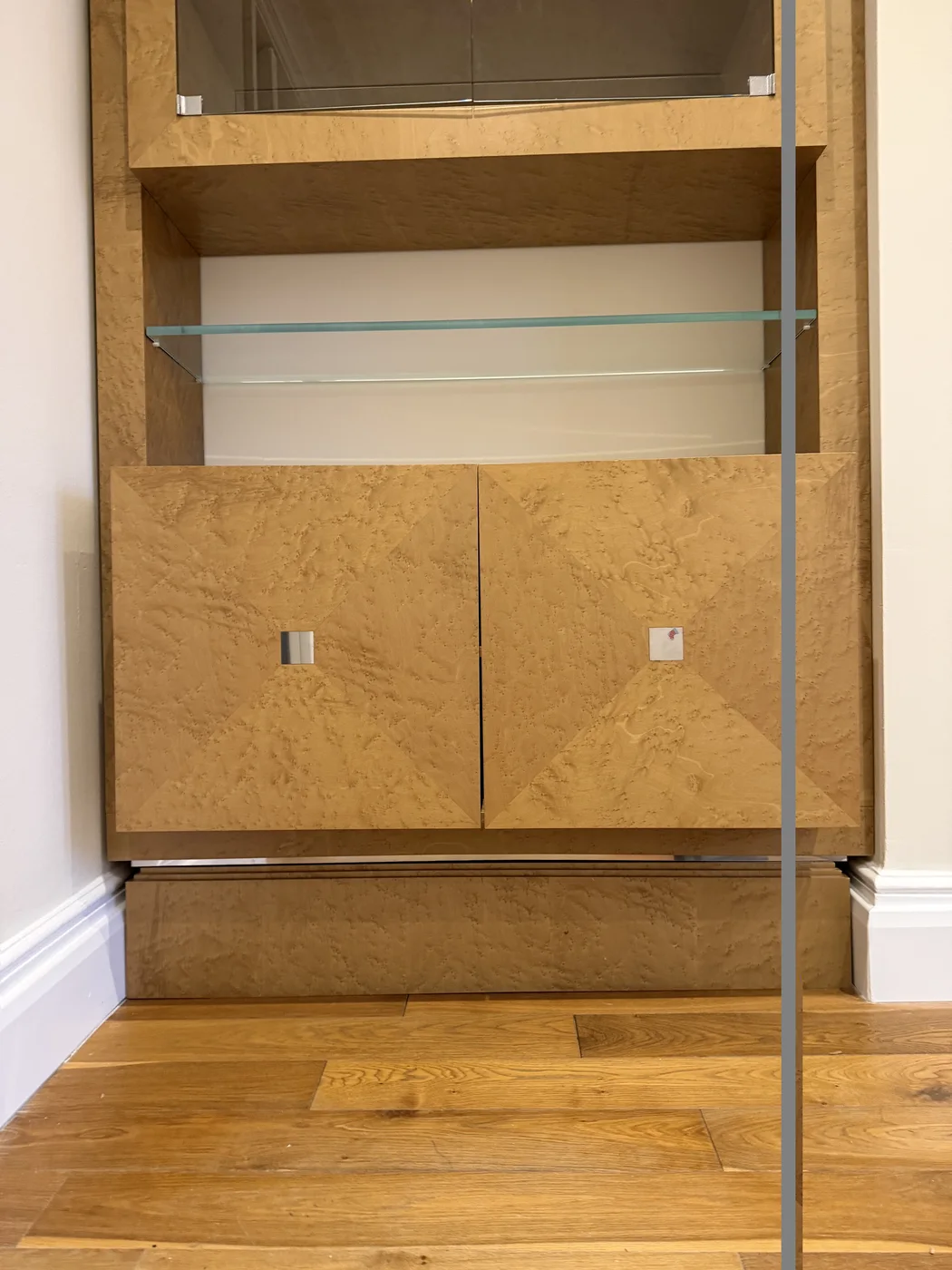 Tall fitted wooden cabinet with glass shelves