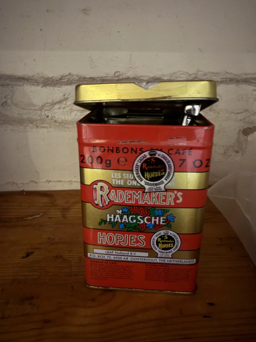 Small red and gold tin holding hand tools